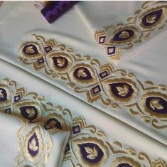 white and gold fabric with purple accents on it