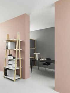 an empty room with pink walls and shelves