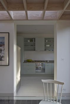 a white chair sitting in the middle of a room