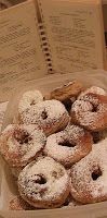 a basket filled with lots of powdered donuts