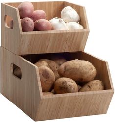 two wooden boxes filled with different types of potatoes and mushrooms, one is white and the other has red