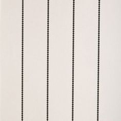 a black and white striped wallpaper with small dots on the bottom half of it