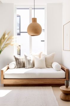 a living room filled with furniture and a white rug on the floor next to a window