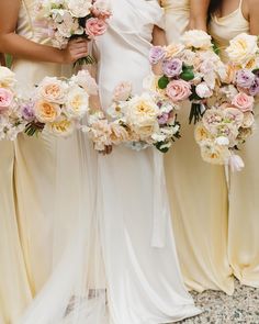 four bridesmaids holding bouquets of flowers in their hands