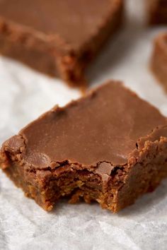 some brownies are sitting on top of white paper