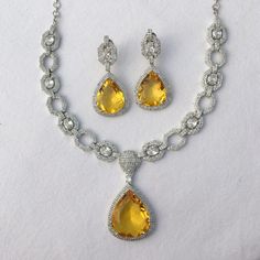 Yellow Diamond Necklace Canary American Diamond Set Yellow Moissanite Pendant Sabyasachi Jewelry Set Pakistani Jewelry CZ Sets *PRODUCT DETAIL* *Material: Brass *Plating: White Rhodium Plated *Stone: AAA Quality CZ . *DIMENSIONS * *Necklace- Weight: 54 gm, One side Length 9.8 Inches, Drop Length:- 6.5 Inch. *Pendant- Length 2.2 Inches, Width:- 1.2 Inches. *Earrings- Weight: 13 gm each, Length: 2.15 Inches, Width: 1 Inches (push back) *ABOUT PRODUCT* *Beautiful Silver Necklace Set Studded with AA Yellow Jewelry Set, Luxury Citrine Gemstone Jewelry, Wedding Crystal Plated Necklaces, Luxury Amber Jewelry For Formal Occasions, Dazzling Yellow Gold Jewelry With Stones, Teardrop Jewels Jewelry For Formal Occasions, Citrine Fine Jewelry For Formal Occasions, Dazzling Pear-shaped Jewelry For Formal Occasions, Formal Teardrop Jewels Jewelry