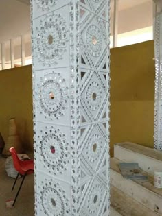 a tall white sculpture sitting in the middle of a room