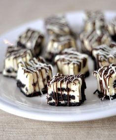 several pieces of cake on a plate with chocolate drizzled over it and white icing