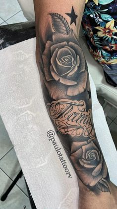 a black and white rose tattoo on the arm