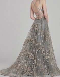 the back of a woman's dress with flowers on it, and an open back