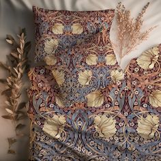 an image of a decorative bed spread with feathers on it