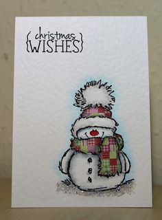 a christmas card with a snowman wearing a hat and scarf on top of it