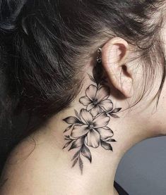 a woman's neck with a flower tattoo on her left side ribcage