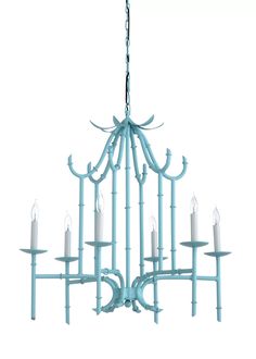 a light blue chandelier with candles hanging from it's sides and arms