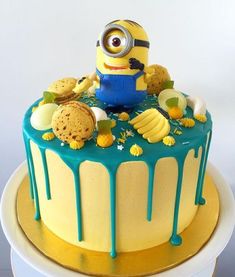 a yellow and blue cake with a minion on top