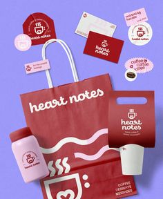 a red bag with coffee and some stickers around it on a purple surface next to other items