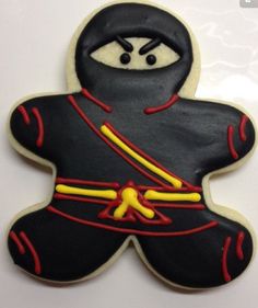 a decorated cookie shaped like a ninja