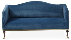 a blue velvet couch with gold trim