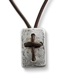 a cross on a leather cord with a metal pendant hanging from it's side