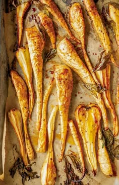 baked chicken wings on a baking sheet with herbs and seasonings in the bottom right corner