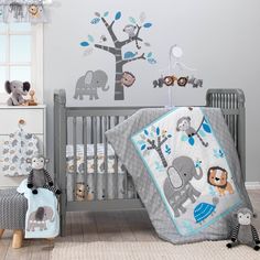 a baby crib with an elephant and giraffe theme