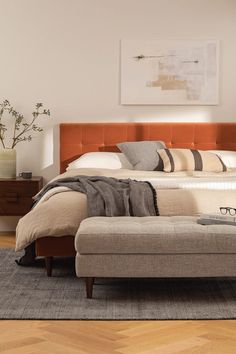 a bed sitting on top of a wooden floor next to a window