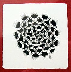 a red frame with a black and white drawing on it that has circles in the center