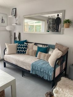 a living room with a couch and mirror