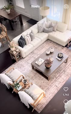 an aerial view of a living room with couches, chairs and coffee table in it