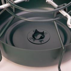 the bottom part of an outdoor cooking pot is shown with metal handles and ring around it