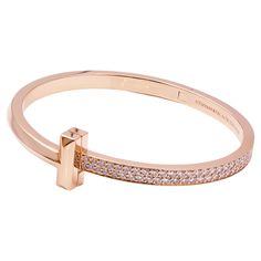 Tiffany & Co. T1 Hinged Bangle in Rose Gold 18k rose gold with round brilliant diamonds Carat total weight 2.18 Size medium, Fits wrists up to 6.25" Retail: $27,000.00 Tiffany Bangle Tiffany & Co., Luxury Pink Gold Bracelet For Formal Occasions, Luxury Pink Gold Bracelet For Formal Events, Luxury Pink Gold Bracelets For Formal Occasions, Luxury Pink Gold Bracelet, Luxury Rose Gold Diamond Bracelet With Pave Setting, Luxury Rose Gold Bracelet With Polished Finish, Formal Rose Gold Diamond Bracelet With Pave Setting, Everyday Luxury Rose Gold Bracelets With Pave Setting