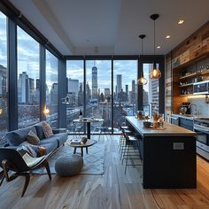 a living room filled with furniture and lots of windows next to a large window covered kitchen