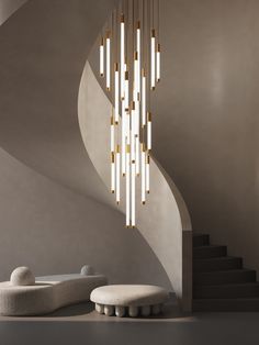 a modern chandelier hanging from the ceiling in a room with white walls and stairs