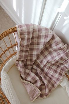 a blanket sitting on top of a wicker chair