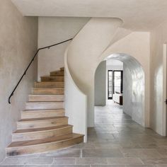 a staircase with wooden steps leading up to the second floor