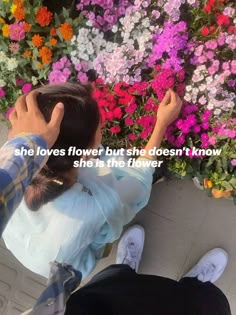 two people sitting in front of flowers with the caption she loves flower but she doesn't know she's the flower