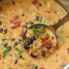 a spoon full of soup with black beans and corn