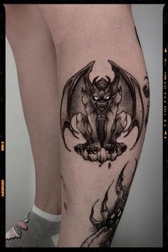 a woman's leg with a bat tattoo on the side of her thigh and legs