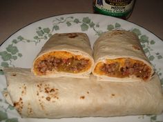 two burritos sitting on top of a white plate