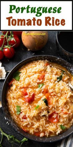 a pan filled with rice and tomatoes on top of a table next to other foods