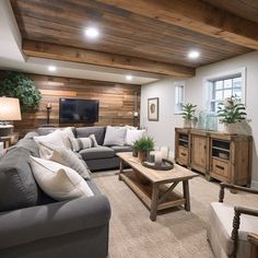 a living room filled with furniture and a flat screen tv mounted to the wall above it