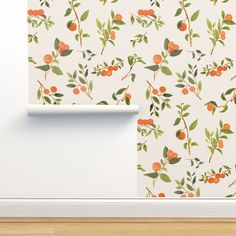 an orange and green wallpaper with small leaves on it next to a white door