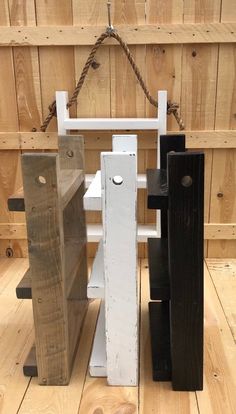 three pieces of wood sitting on top of a wooden floor