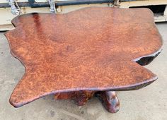 a wooden table sitting on top of a cement ground