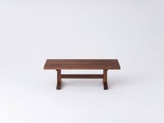 a wooden bench sitting on top of a white floor