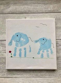 two blue elephants painted on white paper with flowers in the foreground and birds flying overhead