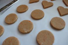 heart shaped cookies are lined up on a baking sheet