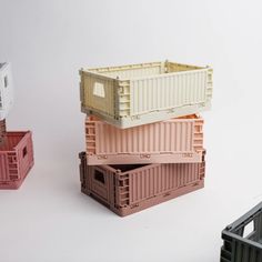 three containers stacked on top of each other with one empty container in the middle and another open container at the bottom