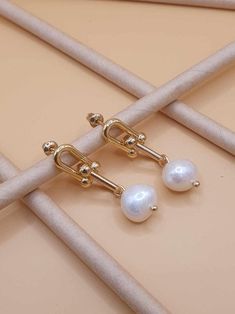 DESCRIPTION: Elegant pearl drop stud earrings featuring dangling pearl links. Perfect for weddings, summer events, and bridesmaid gifts. These chic and timeless earrings add a touch of sophistication to any outfit. BEST FEATURES: Features a timeless pearl drop with dangling links for a chic and sophisticated look. Crafted with premium pearls and durable settings for long-lasting wear. Suitable for weddings, summer events, and daily elegance. Designed for all-day wear without discomfort. Ideal for brides, bridesmaids, and special occasions. ADVANTAGES: Enhances any outfit with classic elegance. Durable and tarnish-resistant for lasting beauty. Complements both casual and formal attire. Lightweight for comfortable extended wear. Makes a thoughtful, stylish gift for loved ones. OUR GUARANTEE Jewelry For Summer, Timeless Earrings, Customer Gifts, Summer Bride, Bridesmaid Gift Ideas, Earrings Dangling, Link Earrings, Summer Events, Earrings Wedding