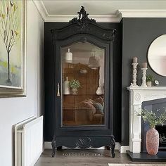 a black grandfather clock sitting in the corner of a living room next to a fireplace